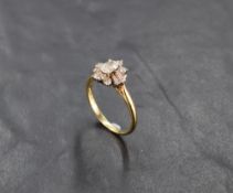 A lady's dress ring having a diamond cluster with central oval diamond surrounded by baguette and