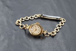 A ladies vintage 9ct gold Rolex wrist watch having baton and star dial in gold case on a rolled gold
