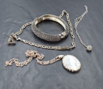 A modern silver locket, of hinged oval form with engraved decoration, marks for Birmingham 1998, and
