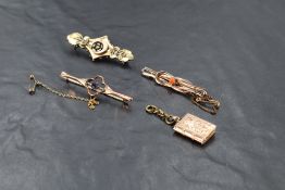 A small selection of yellow metal jewellery, some stamped 9ct including bar brooches and book charm,