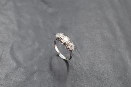 An 18ct white gold three stone diamond ring, the three brilliant-cut diamonds totalling 1.15cts