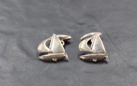 A pair of Queen Elizabeth II silver cuff-links, formed as sailing boats, marks for London 1989,