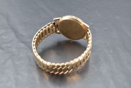 A gents yellow metal cased Rotary wristwatch, thought to be gold, the champagne dial with baton