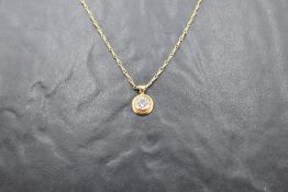 An 18ct gold and diamond pendant, the brilliant-cut diamond measuring 1ct approx, within a raised