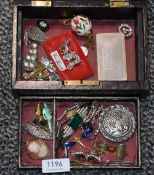 A vintage black leather bound travel jewellery box containing a selection of costume jewellery