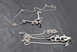 A .925 grade white metal pendant necklace, of scrolling form set with two obsidian type cabochons