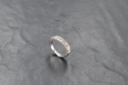An 18ct gold half eternity ring, having a linear arrangement of seven diamond brilliants totalling