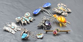 A selection of insect and butterfly brooches, including articulated fly brooch, gilt metal and amber