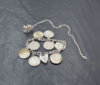 A silver curb bracelet having padlock clasp and nine sixpences attached, and a silver rocking