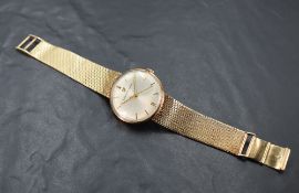 A gents 9ct gold dress watch by Girard Perragaux having a baton numeral dial with gold hands to