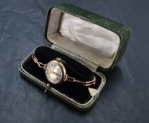 A vintage 9ct rose gold wrist watch having Roman numeral dial in plain circular case on rose gold