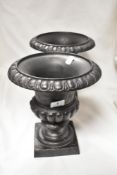 A pair of heavy cast Campana urns of small poroportions