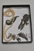 A vintage pearl or pearl effect necklace, four metal brooches and a set of clip on earrings.