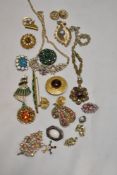 A collection of vintage costume brooches, many with rhinestone detailing.