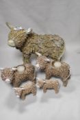 A selection of Highland Cow ornaments including tea light holders