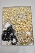 A collection of beaded pearl effect necklaces and one of natural stone.