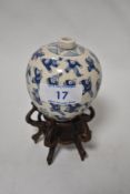 A 19th century Chinese bud vase on intricate wood stand with the 'One hundred boys' depicted in blue