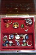 A modern lockable musical jewellery case with a selection of modern costume jewellery rings