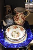 An assortment of vintage and antique ceramics, blue and white platters, fruit bowls, tea pot with