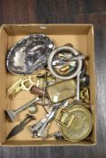 A collection of hardware including gravy boat, cork screws, spoons and a pair of small column candle