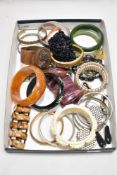 A mixed lot of vintage and retro bangles and bracelets, including natural stone, mid century plastic