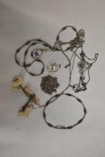 An early plastic Art Deco west highland terrier brooch, a silver tone Taurus pendant, necklaces