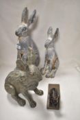 Three composite hare studies and a rabbit door stop.