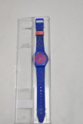 A Whiskas advertising watch having blue rubber strap.