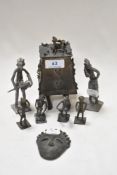 A selection of miniature Benin bronze figures, a container and two similar metal figures.