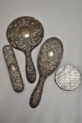 An early 20th century silver plated dressing table set and a silver tone metal compact, of battle