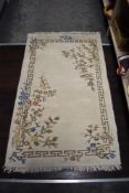 A Traditional rug in beige, green and blue tones.
