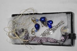 A fine stranded Sterling silver necklace, a silver tone bracelet and a pink rhinestone choker.