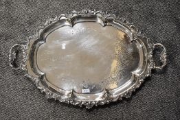 A substantial silver plated butlers tray having raised foliate decoration to edge.