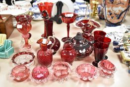 A collection of vintage ruby and cranberry glass wares, vases, baskets and glasses amongst this
