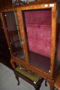 A late 19th or early 20th Century walnut and mahogany display cabinet on cabriole legs
