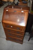 A reproduction yew wood bureau