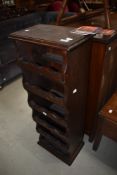 A dark stained pine wine rack