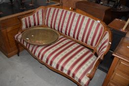 A Continental style walnut settee having shaped frame and classical striped upholstery