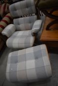 A modern designer easy chair and footstool, in the Eames style with ply frame and tweed style