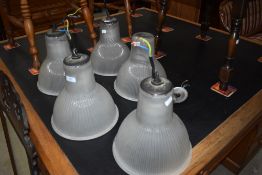 A set of five vintage industrial style ceiling lights, with opaque pressed glass shades