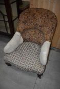 A Victorian spoon back easy chair