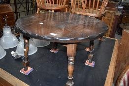 A reproduction oak coffee table having pie crust style decoration to edge, diameter approx. 72cm