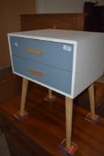 A modern bedside chest of two drawers on beech splay legs