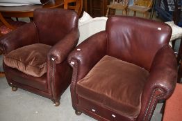 A pair of traditional brown leather tub chairs