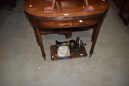 A Victorian mahogany fold over tea table of demi lune form on turned legs, width approx. 92cm