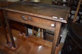 A 19th Century oak side table having frieze drawer with brass drop handle, on square legs, width