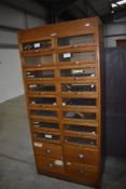 A vintage oak mid-century shopfitting / haberdashery unit having glazed panelled drawers with