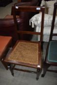 An Edwardian cane seated bedroom chair