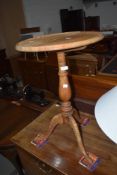 A stripped oak occasional tripod table having circular top, diameter approx. 40cm