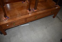 An Oriental hardwood coffee table having frieze drawers, approx. 153 x 56cm